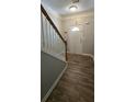 Inviting entryway featuring wood-look tile flooring and a staircase with a wooden handrail at 776 Tulip Poplar Way, Lawrenceville, GA 30044