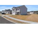Charming two-story home featuring a two-car garage and classic architectural details at 8587 Secretariat Dr, Lithonia, GA 30058