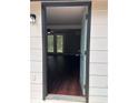 Inviting entryway with hardwood floors leading to a living area with glass paneled doors at 1087 W Adrian Sw Cir, Conyers, GA 30094