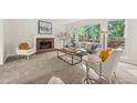 Bright living room featuring a brick fireplace, large windows and plush carpeting at 179 Hunters Crk, Dallas, GA 30157