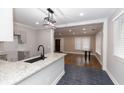 Contemporary kitchen with granite countertops, dark tile flooring, and stainless steel faucet; open to the dining room at 1174 Donnelly Sw Ave, Atlanta, GA 30310