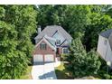 Beautiful aerial view of a two-story brick home surrounded by mature trees at 1614 Summersweet Ln, Dacula, GA 30019