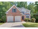 Charming two-story brick home with a two-car garage and well-maintained lawn at 1614 Summersweet Ln, Dacula, GA 30019