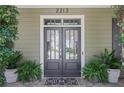 Elegant double front door, framed by manicured plants and a stylish welcome mat at 2213 Parkview Nw Ct, Atlanta, GA 30318