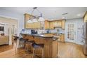 Spacious kitchen with custom wood cabinets, stainless appliances, breakfast bar, and access to living area at 1665 Cunningham Road Southwest Sw Rd, Marietta, GA 30008