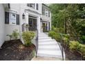 Elegant front entrance with wrought iron railings leading to a covered front porch at 2184 Summerchase Dr, Woodstock, GA 30189