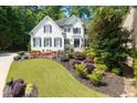 Landscaped front yard view showcases the bright, well-maintained home with beautiful yard at 2184 Summerchase Dr, Woodstock, GA 30189