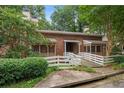 Brick exterior with screened in porches and a charming white picket fence at 325 Quail Run, Roswell, GA 30076