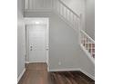 Bright foyer featuring wood floors, a staircase, and neutral paint at 325 Quail Run, Roswell, GA 30076