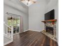 Living room with high ceilings, stone fireplace, wood floors and sliding glass doors to a screened porch at 325 Quail Run, Roswell, GA 30076