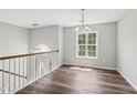 Bright dining room featuring hardwood floors, modern light fixture and large window allowing plenty of natural light at 346 Majestic Run, Temple, GA 30179