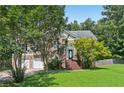 Beautiful home with a stone and siding exterior, complemented by lush landscaping and a welcoming front porch at 346 Majestic Run, Temple, GA 30179