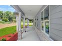 Inviting side porch with brick accents and ample natural light at 1943 Lake Chase Ln, Jonesboro, GA 30236