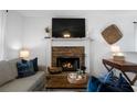 Cozy living room with a stone fireplace, creating a warm and inviting atmosphere at 427 Pleasant Way, Temple, GA 30179