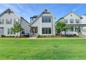 Charming two-story home with white siding, black framed windows and well-manicured lawn at 3415 Crop Corner Rd, Suwanee, GA 30024