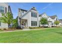 Charming two-story home with white siding, black framed windows and well-manicured lawn at 3415 Crop Corner Rd, Suwanee, GA 30024