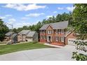 Traditional brick home in a serene neighborhood setting with well-maintained landscaping and ample parking at 1079 Angel Ln, Powder Springs, GA 30127