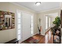 Warm and welcoming foyer with hardwood floors, a stylish mirror, and ample natural light at 1079 Angel Ln, Powder Springs, GA 30127