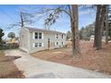 Two-story home with brick facade, mature trees, and a concrete driveway at 216 Scarsdale Dr, Riverdale, GA 30274