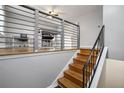 View of the wooden stairs with a black railing leading to a landing at 216 Scarsdale Dr, Riverdale, GA 30274