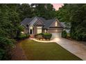 Charming brick home with inviting curb appeal, featuring manicured landscaping and a two-car garage at 8189 N Pine Cone N Dr, Villa Rica, GA 30180