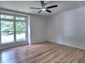 Inviting bedroom with hardwood floors, a modern ceiling fan, and a large window that brings in natural light at 2540 Rocky Springs Dr, Marietta, GA 30062