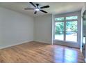 Bright bedroom featuring hardwood floors, a ceiling fan, and a large window offering a pleasant view at 2540 Rocky Springs Dr, Marietta, GA 30062