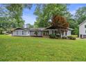 Well-maintained single-story home with a lush green lawn and mature trees at 4370 Mabry Ln, Roswell, GA 30075