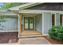 Inviting front porch with a wooden deck and a stylish double-door entrance at 4370 Mabry Ln, Roswell, GA 30075