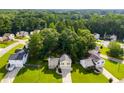 Beautiful aerial view of the home nestled among lush trees, expansive lawns, and neighborhood streets at 604 Meadows Ct, Villa Rica, GA 30180