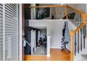 Open foyer featuring hardwood floors, staircase with iron railing, and view into adjacent living space at 7125 Creeksong Dr, Douglasville, GA 30134