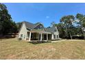 Beautiful home with a covered front porch and black window shutters nestled among lush trees at 22 Stratford Way, Kingston, GA 30145