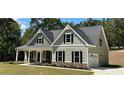 Attractive home with attached garage, dark shutters, stone accents and manicured landscaping at 22 Stratford Way, Kingston, GA 30145