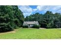 Quaint single-story home nestled among mature trees with lush green lawn at 101 Tide Water Way, Rockmart, GA 30153
