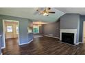 Comfortable living room featuring a fireplace, wood-look flooring, and easy access to the kitchen at 101 Tide Water Way, Rockmart, GA 30153