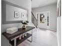 Bright entryway with a large mirror, decorative table, and light wood floors at 124 Freedom Dr, Acworth, GA 30102