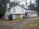 Charming split-level home with stone accents and a well-maintained front yard surrounded by mature trees at 3447 Stonewall Nw Dr, Kennesaw, GA 30152