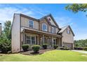 Attractive two-story home with brick and siding, a well-kept lawn, and covered porch at 1883 Jameson Cir, Lawrenceville, GA 30043