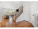 Inviting entryway featuring hardwood floors, staircase, and view into living room at 3505 Aqua Point Pl, Cumming, GA 30041