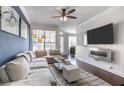 Comfortable living room with stylish furnishings, a ceiling fan, and a mounted TV for relaxed living at 3777 Peachtree Ne Rd # 1326, Atlanta, GA 30319