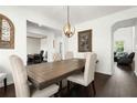 Elegant dining room showcasing hardwood floors, modern lighting, and comfortable seating at 1800 Pearson St, Loganville, GA 30052