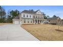 Beautiful brick home with a long driveway, attached garage, and well-manicured lawn at 185 Haverling Pass, Hampton, GA 30228