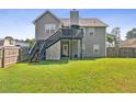 View of the home's backyard featuring a deck, staircase, and a well-maintained lawn at 30 Freedom Ne Dr, Cartersville, GA 30121
