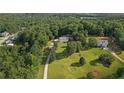 Aerial view of a large home on a sprawling lot with mature trees in a tranquil setting at 450 Ledbetter Rd, Villa Rica, GA 30180