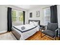 Serene bedroom with neutral tones, hardwood floors, and a comfortable bed at 1788 Campbellton Sw Rd, Atlanta, GA 30311