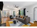 Cozy living room featuring a modern sofa, hardwood floors, and an abundance of natural light at 1788 Campbellton Sw Rd, Atlanta, GA 30311