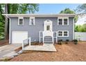 Split-level home has a grey brick facade, a white front door, and a one-car garage at 2099 Redbud Sw Ct, Marietta, GA 30008