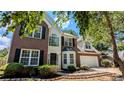 Charming two-story brick and vinyl home with a well-maintained lawn and inviting curb appeal at 2565 Rainmaker Dr, Decatur, GA 30034