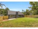 Spacious backyard with a new wooden fence and lush green grass, perfect for outdoor activities at 8689 Cedar Creek Rdg, Riverdale, GA 30274