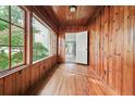 Cozy sun room with wood paneling and lots of windows, a door leading to another room with light blue walls at 10 Shadburn Ferry Rd, Buford, GA 30518